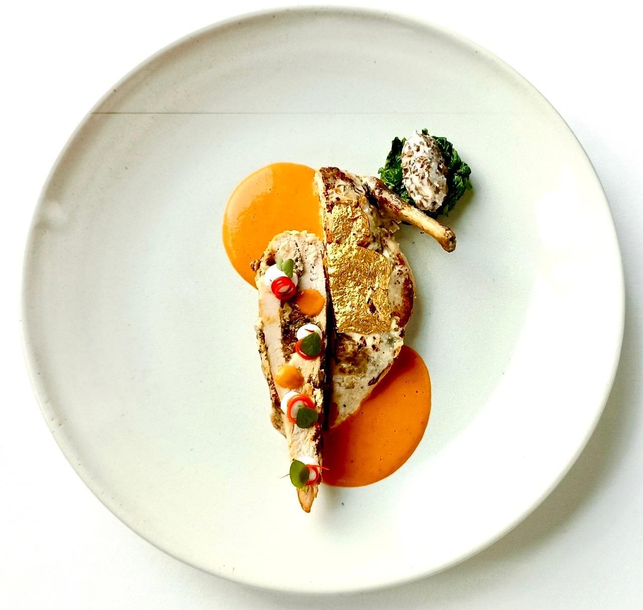 Roast poultry with gold leaf and orange sauce