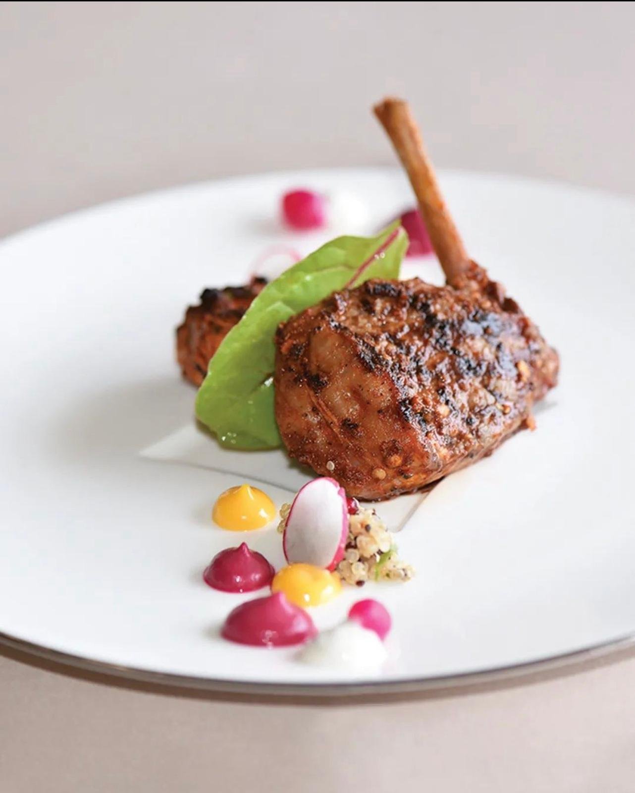 Spiced lamb chop with coloured sauces and radish