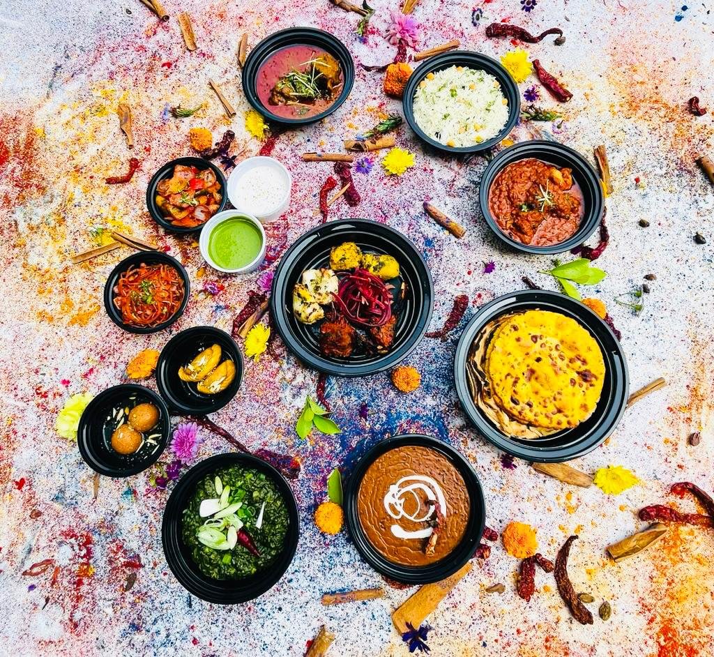 Indian feast of curries, breads and rice on a colourful table